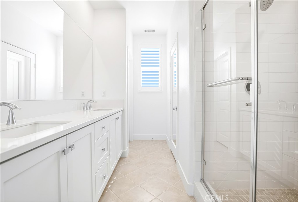 3140 Cove Street Rancho Mission Viejo, CA 92694 - Photo 19 of 69 a bathroom with a double vanity sink and a mirror