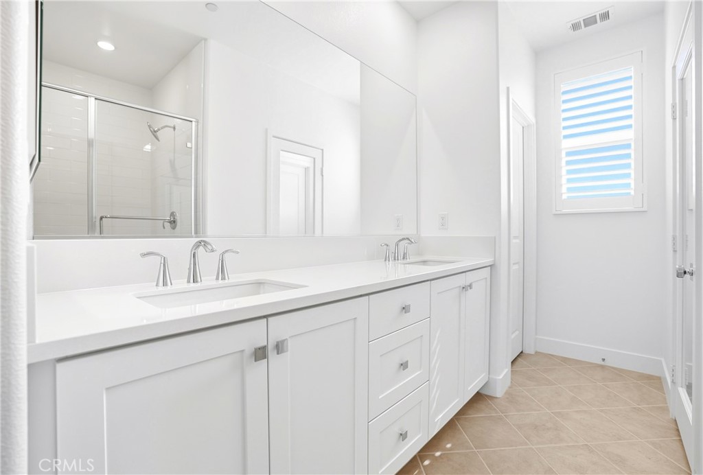 3140 Cove Street Rancho Mission Viejo, CA 92694 - Photo 20 of 69 a bathroom with double sink and a mirror