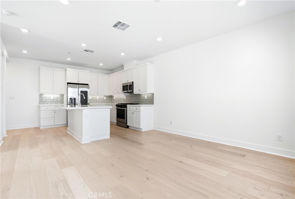 3140 Cove Street Rancho Mission Viejo, CA 92694 - Photo 3 of 69 a view of kitchen with wooden floor