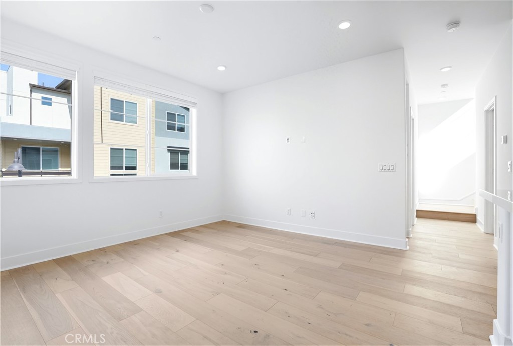 3140 Cove Street Rancho Mission Viejo, CA 92694 - Photo 8 of 69 an empty room with a fireplace and wooden floor