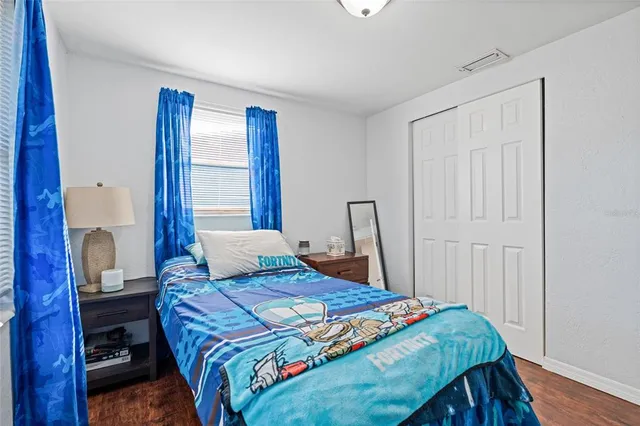 a bedroom with a bed and a window