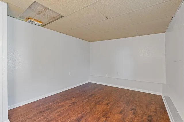 a view of a room with wooden floor