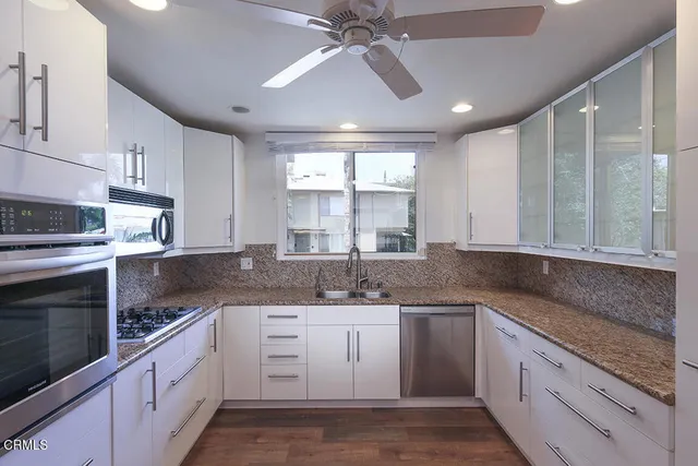 a kitchen with a sink stove and cabinets