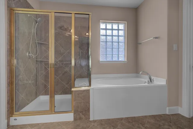 a white bath tub sitting next to a shower