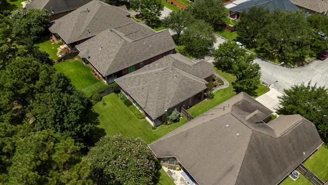 an aerial view of a house with a yard