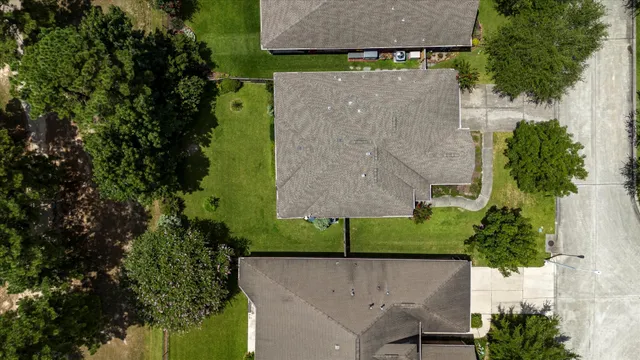 an aerial view of a house with a yard
