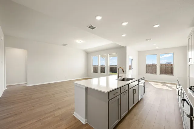 a kitchen with stainless steel appliances granite countertop a stove and a sink
