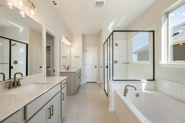 a bathroom with a tub and shower