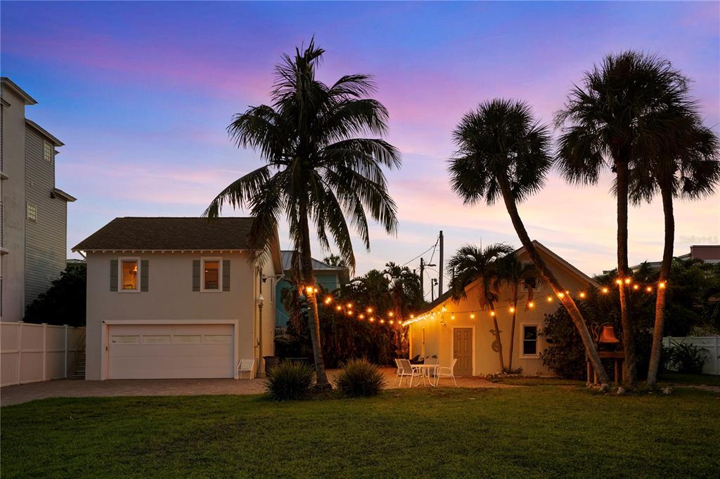 702 Pass A Grille Way St. Pete Beach, FL 33706 - Photo 34 of 41 a view of a house with a big yard and palm trees