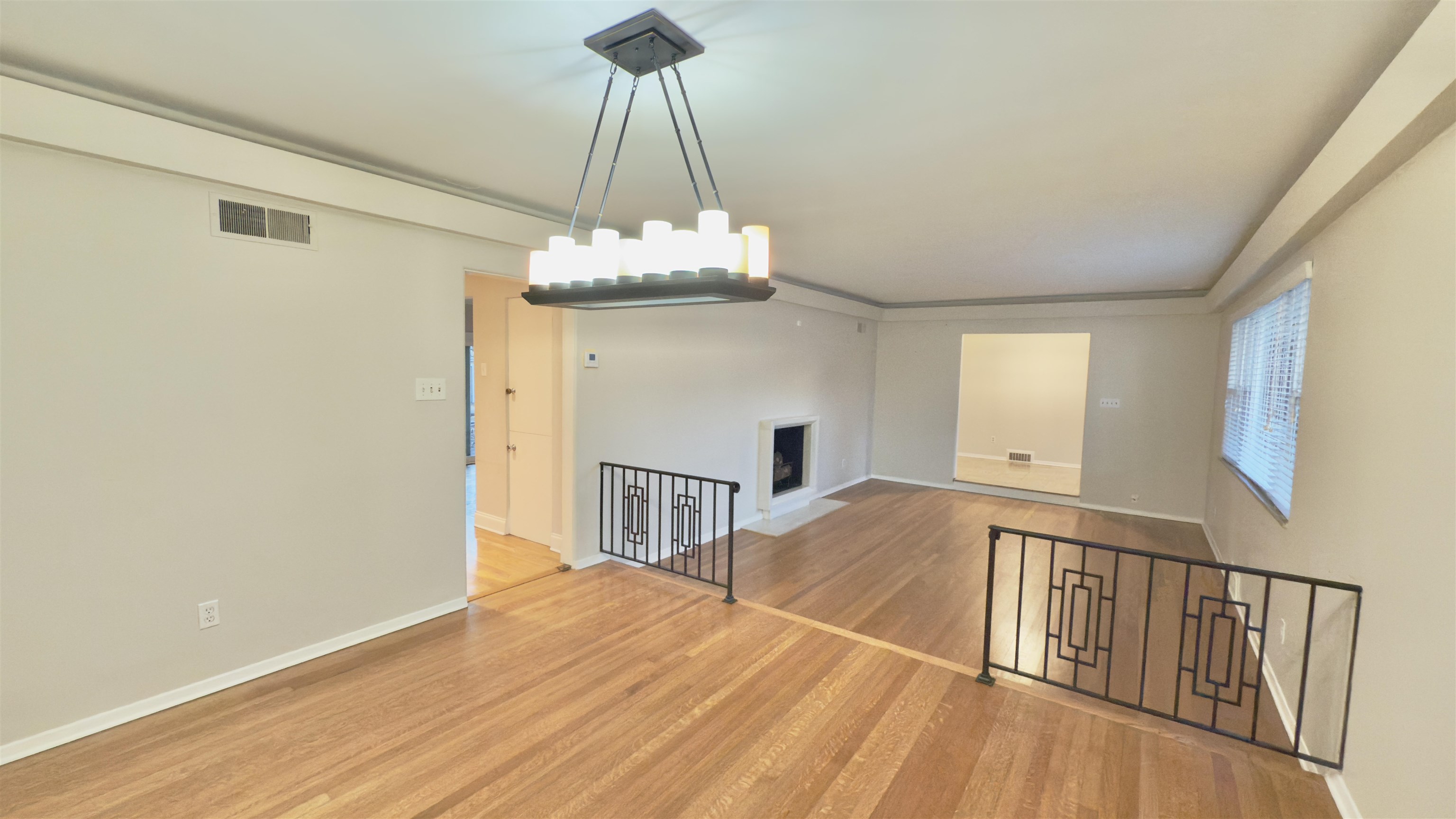 5209 Walnut Grove Road Memphis, TN 38117 - Photo 11 of 30 Unfurnished living room featuring a fireplace and light wood-style flooring