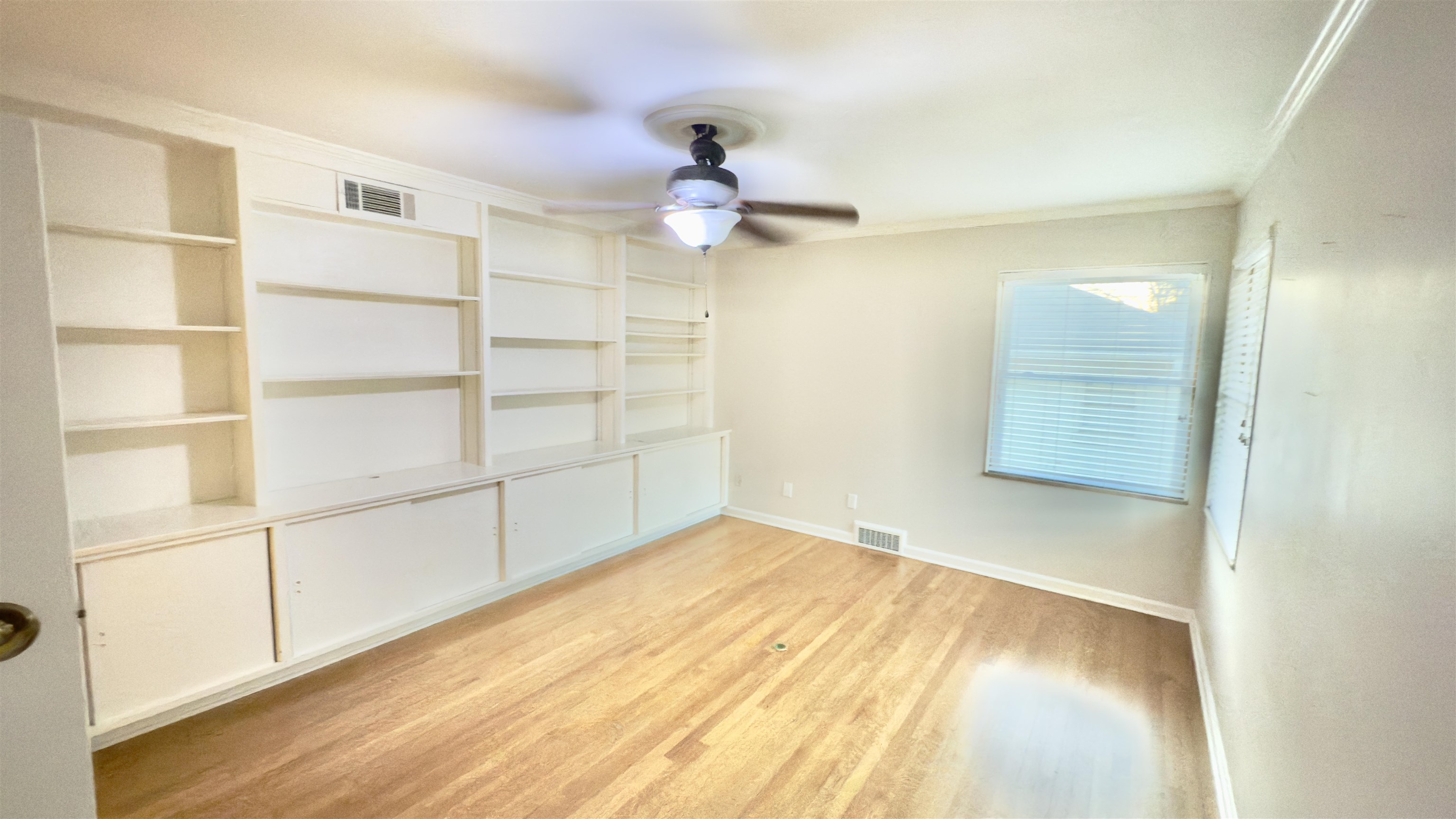 5209 Walnut Grove Road Memphis, TN 38117 - Photo 23 of 30 a view of empty room with wooden floor and fan