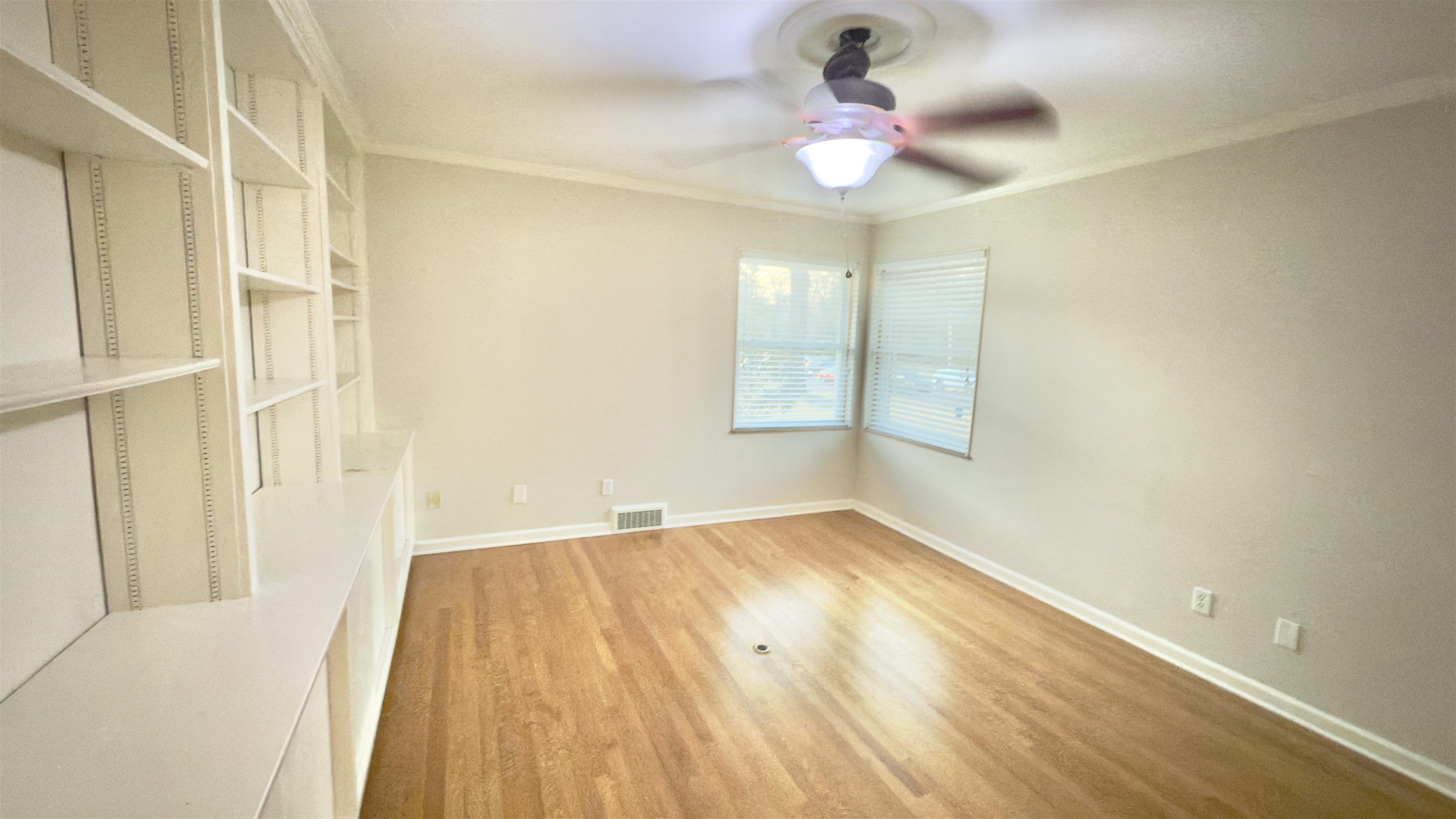 5209 Walnut Grove Road Memphis, TN 38117 - Photo 24 of 30 Empty room with crown molding, wood finished floors, and a ceiling fan