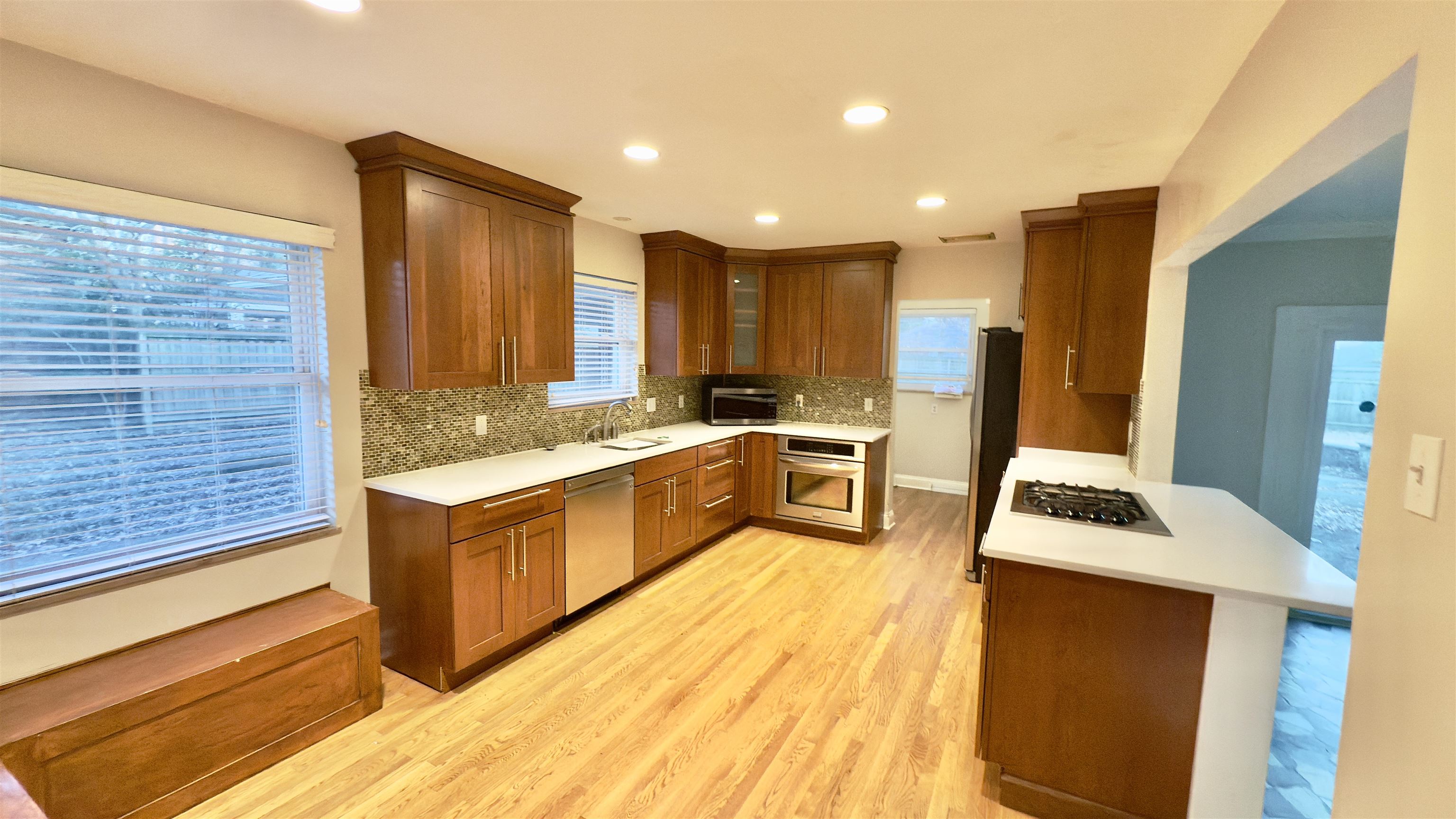 5209 Walnut Grove Road Memphis, TN 38117 - Photo 3 of 30 a kitchen with stainless steel appliances granite countertop a stove a sink and a refrigerator