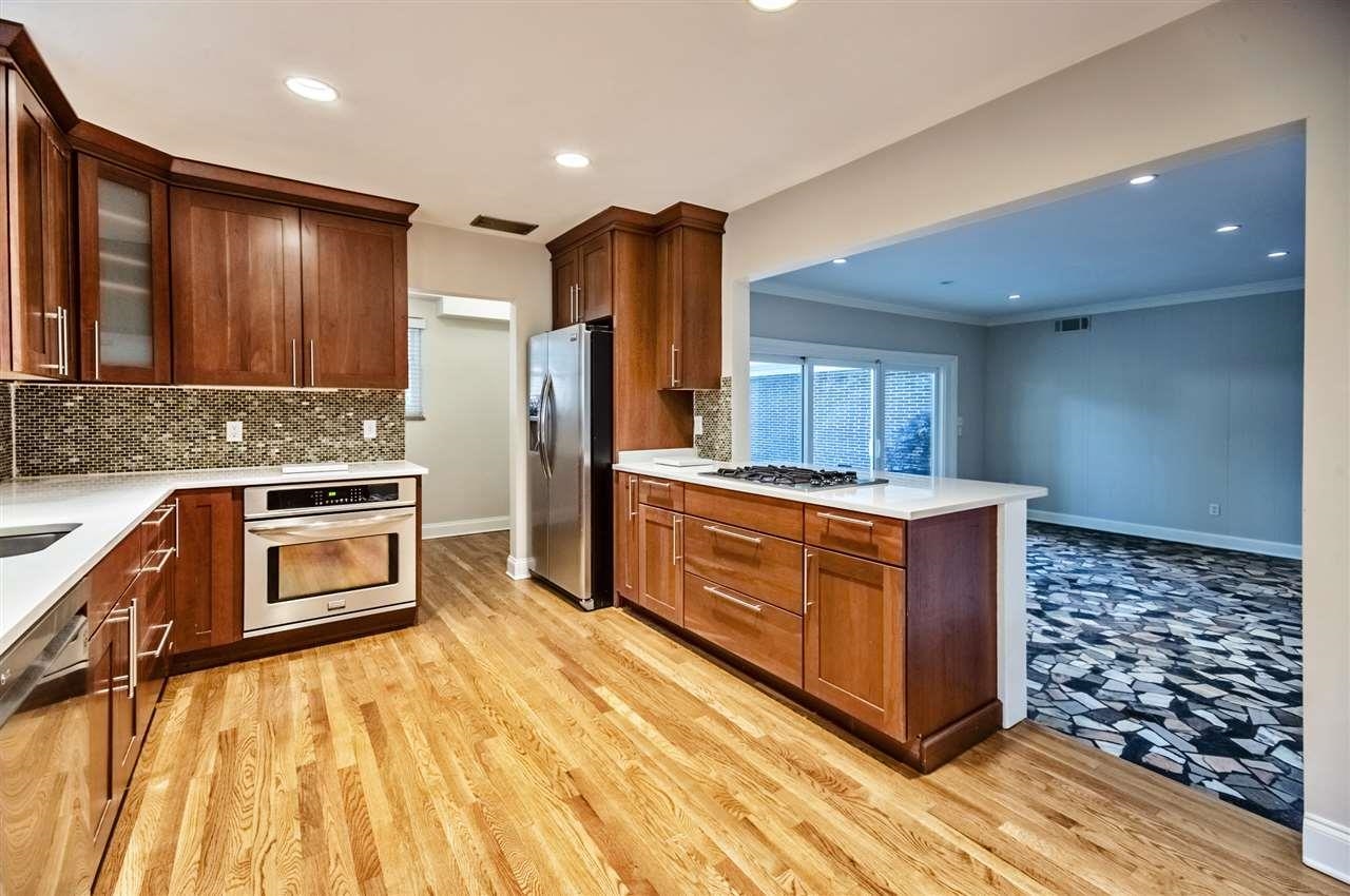 5209 Walnut Grove Road Memphis, TN 38117 - Photo 4 of 30 a kitchen with stainless steel appliances kitchen island granite countertop a stove and a refrigerator