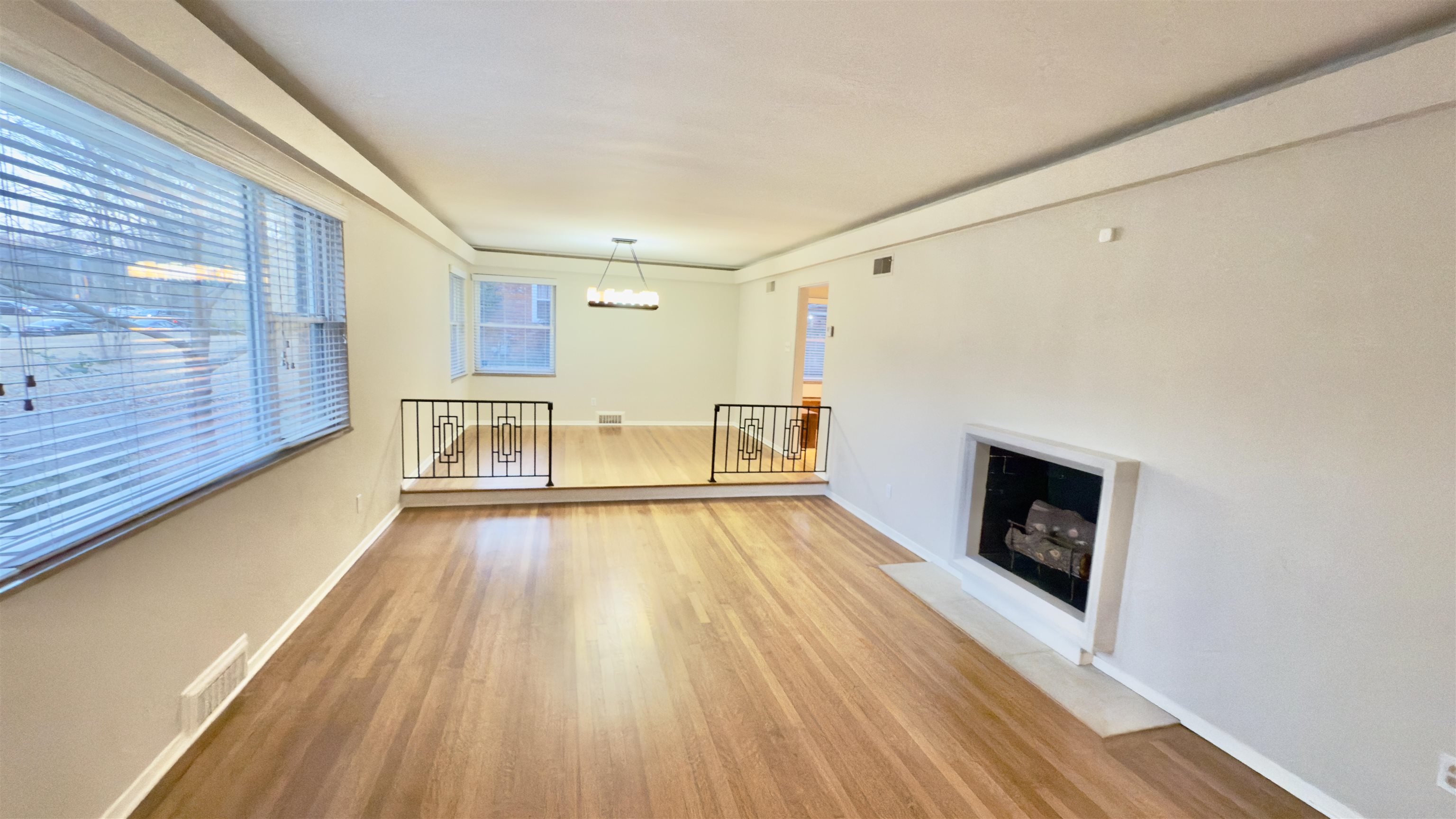 5209 Walnut Grove Road Memphis, TN 38117 - Photo 9 of 30 a view of empty room with wooden floor and fireplace