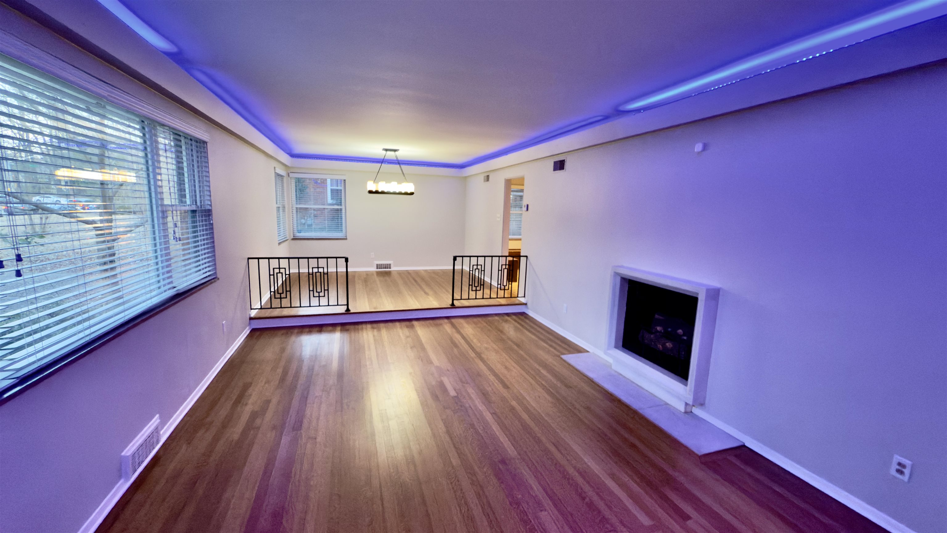 5209 Walnut Grove Road Memphis, TN 38117 - Photo 10 of 30 a view of empty room with wooden floor and fireplace