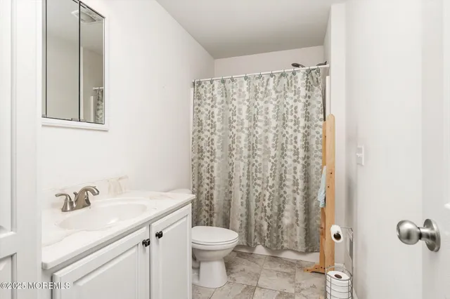 a bedroom with a bed and a view of bathroom