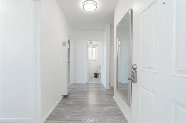 a view of a hallway with wooden floor
