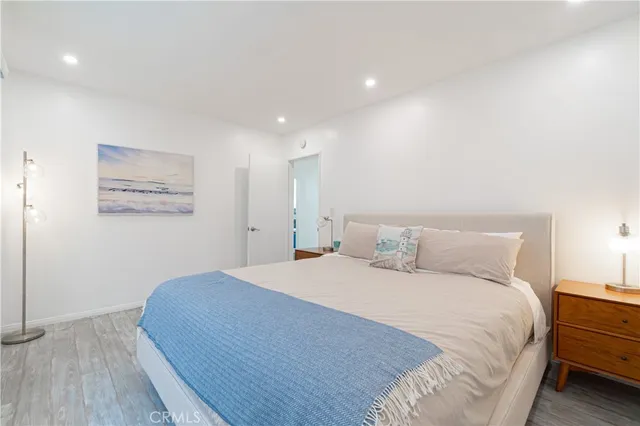 a large bed sitting in a bedroom and a table