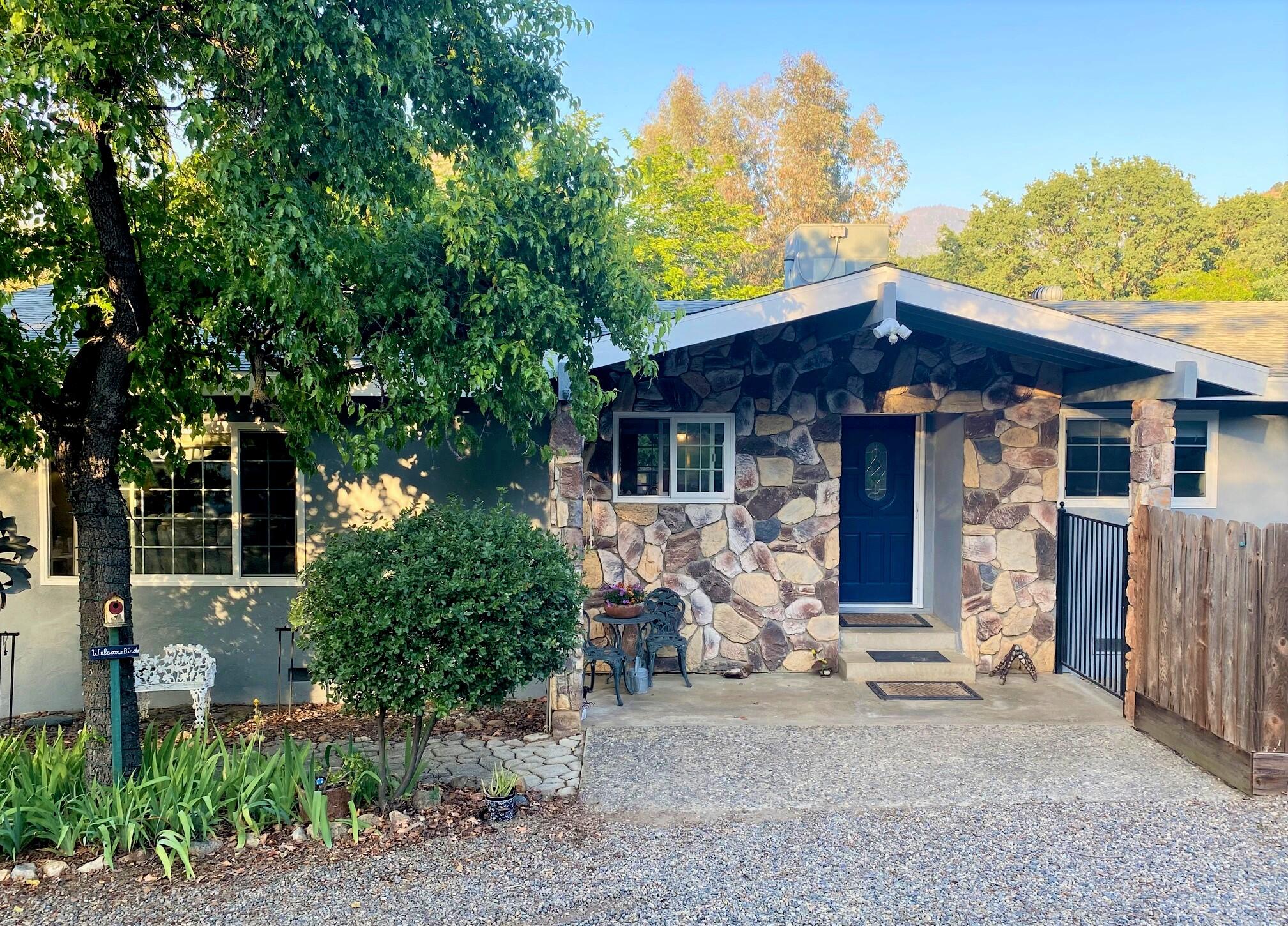 40968 Grouse Drive Three Rivers, CA 93271 - Photo 1 of 31 a front view of a house with garden