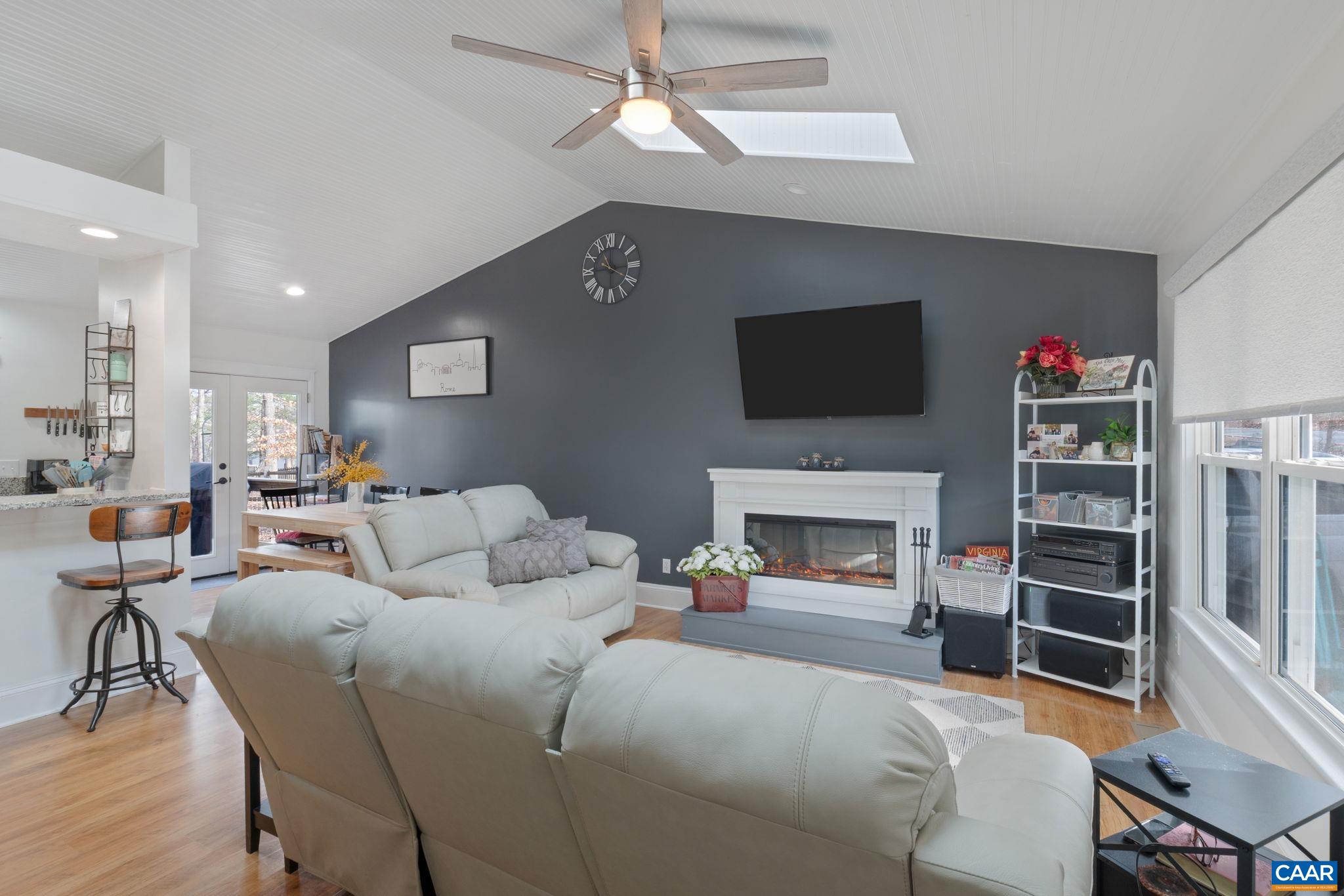 1 Hatchechubee Road Palmyra, VA 22963 - Photo 6 of 48 a living room with furniture a fireplace and a flat screen tv