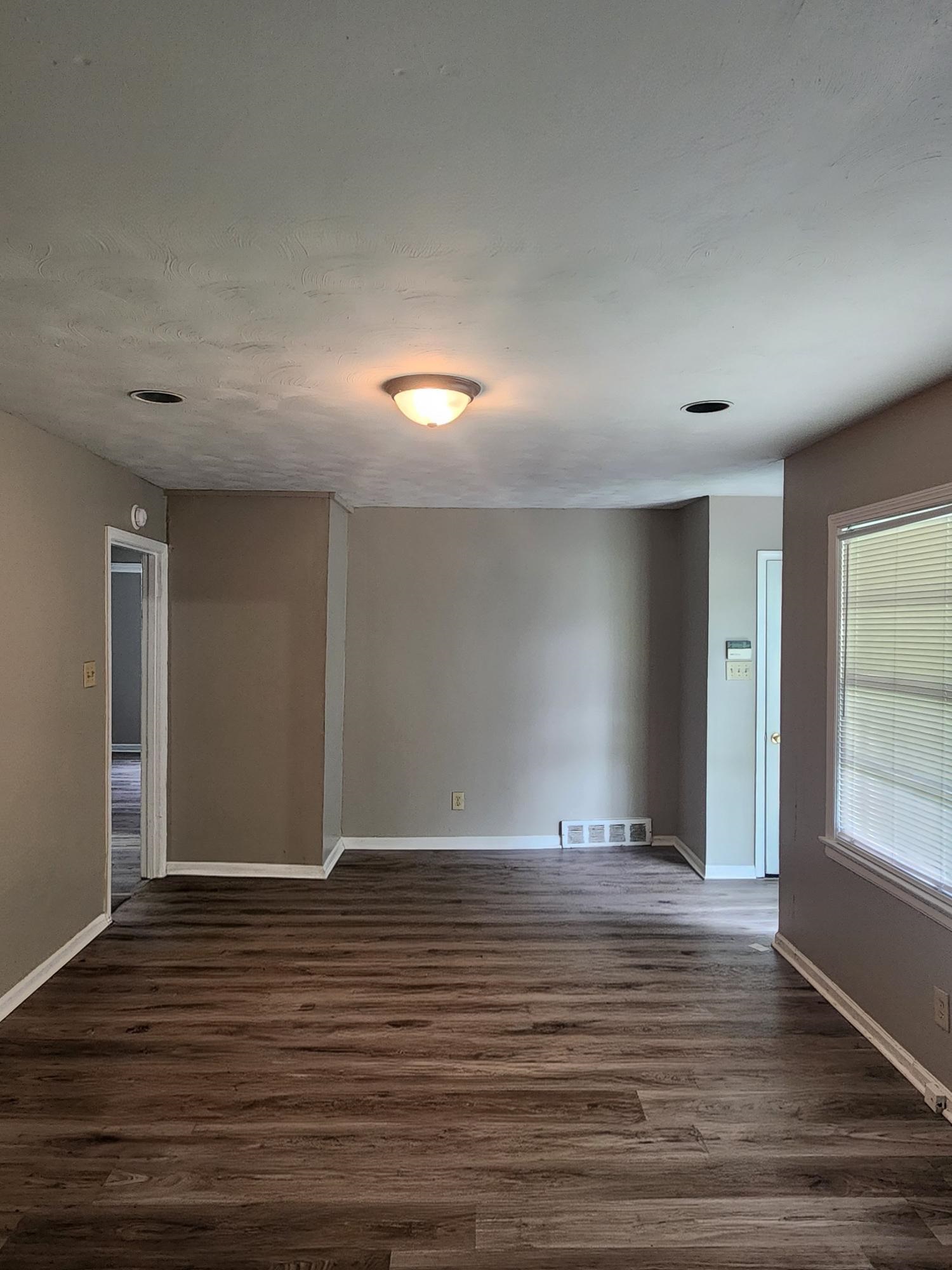 3645 Brompton Road Memphis, TN 38118 - Photo 10 of 17 a view of an empty room with window and wooden floor
