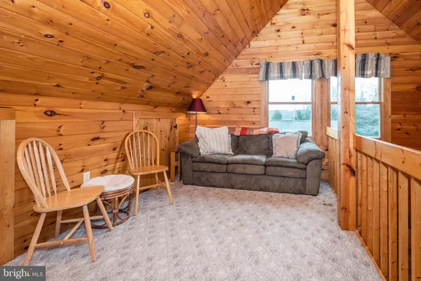 a living room with furniture a ceiling fan and a rug