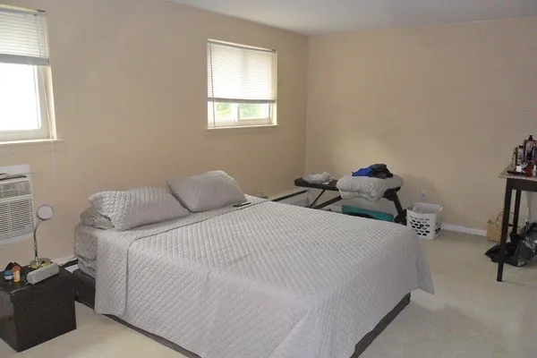 a bedroom with a bed and a dresser