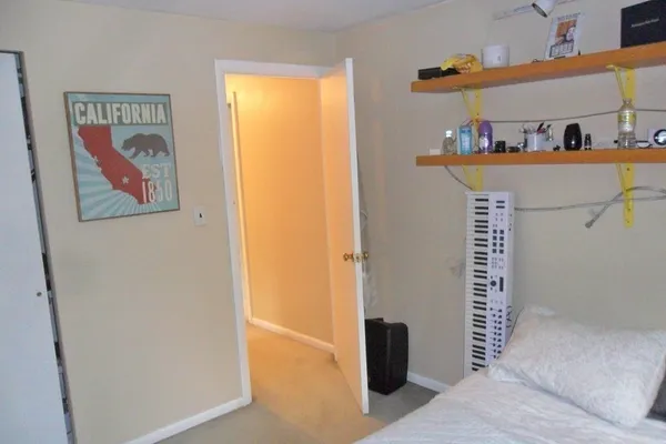 a view of a hallway with paintings on the wall