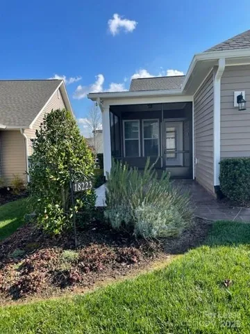 a view of a house with a small yard and plants