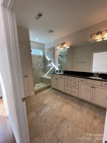 a large white kitchen with a sink and cabinets