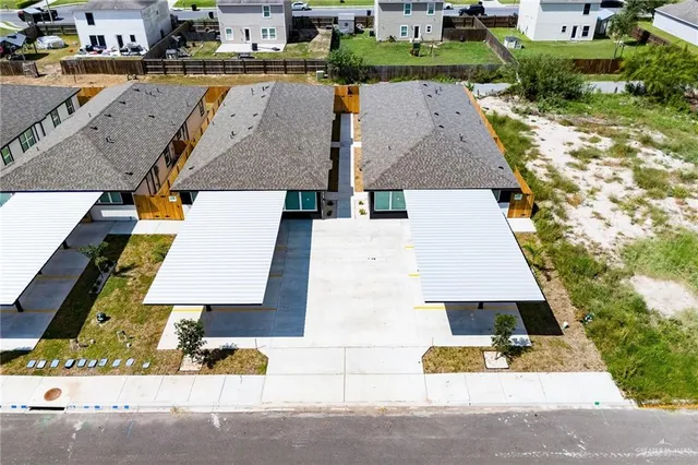 an aerial view of a house with swimming pool and seating space