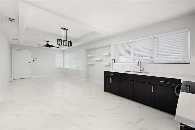 a kitchen with a sink cabinets and window