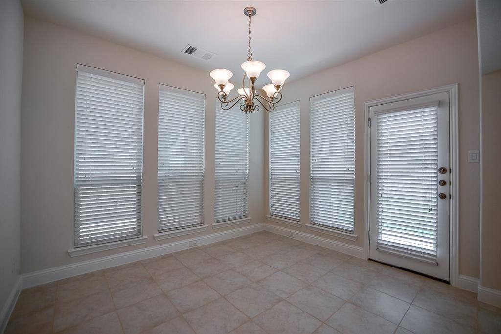 3412 Damsel Sauvage Lane Lewisville, TX 75056 - Photo 13 of 28 a view of a livingroom with a chandelier fan and windows