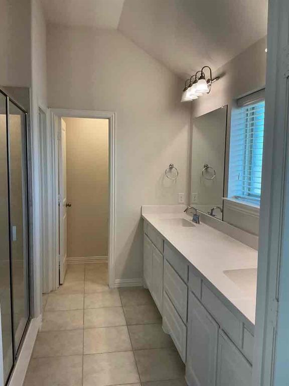 3412 Damsel Sauvage Lane Lewisville, TX 75056 - Photo 17 of 28 a bathroom with a double vanity sink and mirror