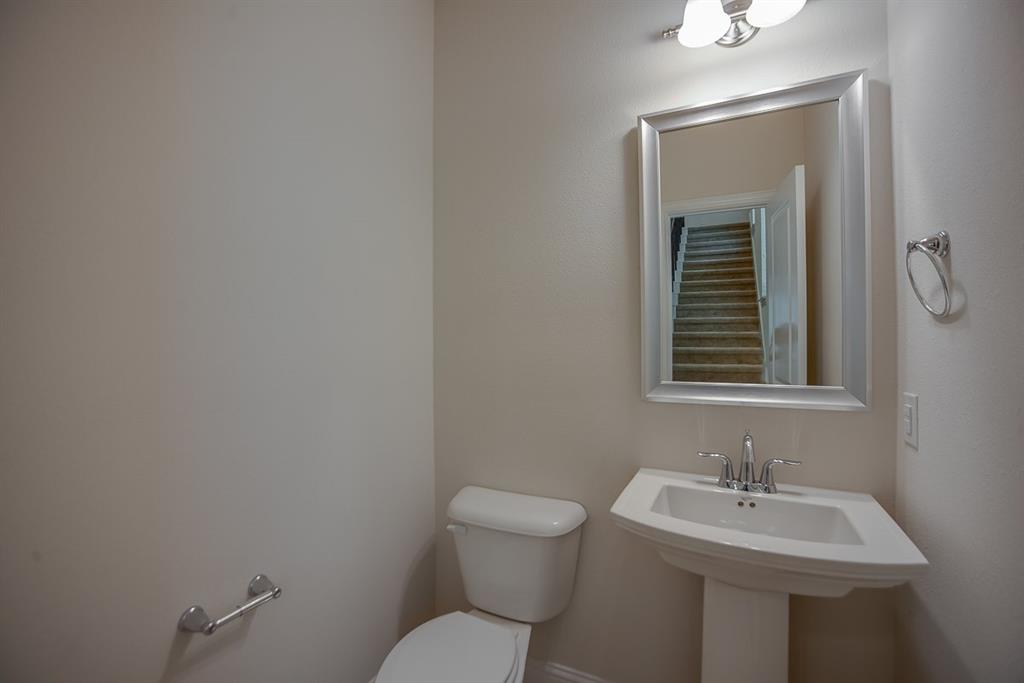 3412 Damsel Sauvage Lane Lewisville, TX 75056 - Photo 18 of 28 a bathroom with a toilet sink and mirror