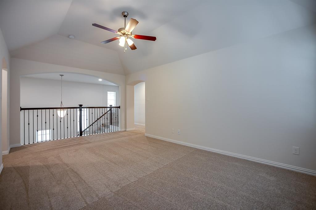 3412 Damsel Sauvage Lane Lewisville, TX 75056 - Photo 20 of 28 a view of an empty room with a chandelier fan