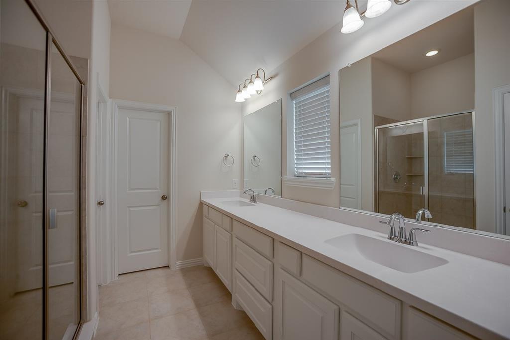 3412 Damsel Sauvage Lane Lewisville, TX 75056 - Photo 22 of 28 a bathroom with double sink and a mirror