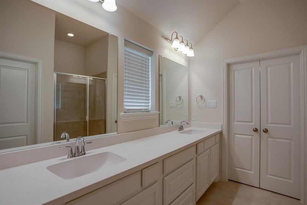 3412 Damsel Sauvage Lane Lewisville, TX 75056 - Photo 23 of 28 a bathroom with double vanity sinks and a mirror