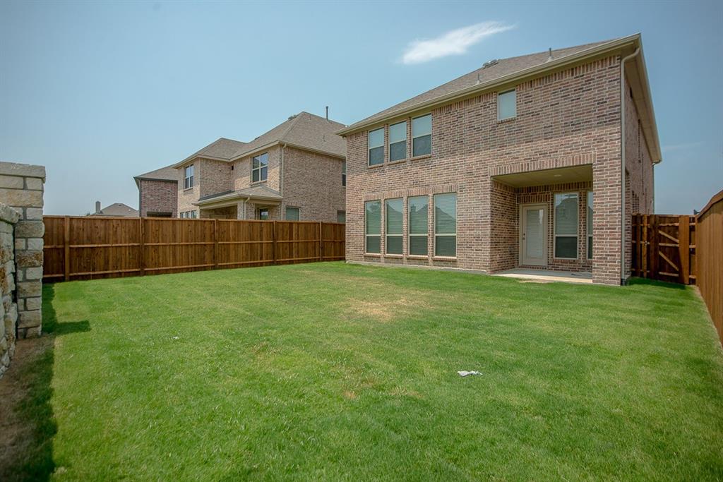 3412 Damsel Sauvage Lane Lewisville, TX 75056 - Photo 27 of 28 a front view of a house with a garden