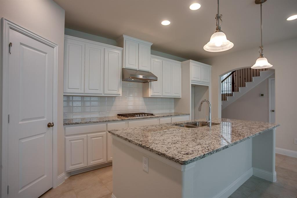 3412 Damsel Sauvage Lane Lewisville, TX 75056 - Photo 6 of 28 a kitchen with stainless steel appliances granite countertop a sink a stove and a granite counter tops