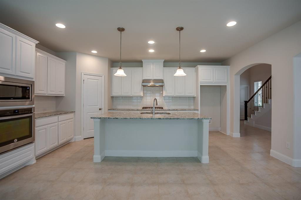 3412 Damsel Sauvage Lane Lewisville, TX 75056 - Photo 7 of 28 a large kitchen with cabinets