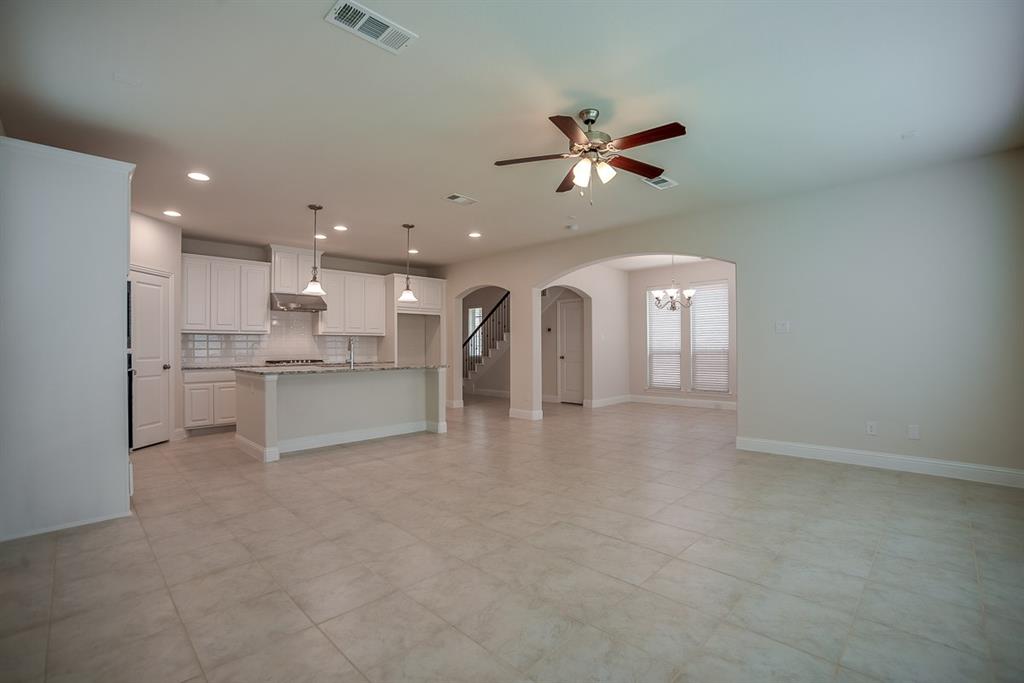 3412 Damsel Sauvage Lane Lewisville, TX 75056 - Photo 8 of 28 a view of a kitchen with a sink and stainless steel appliances