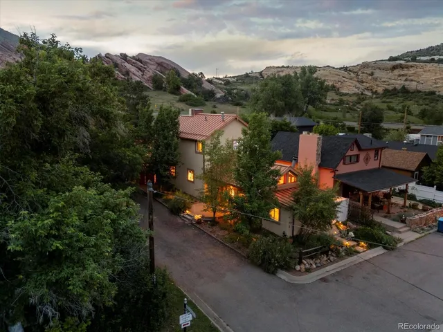 an aerial view of a house with garden space and street view