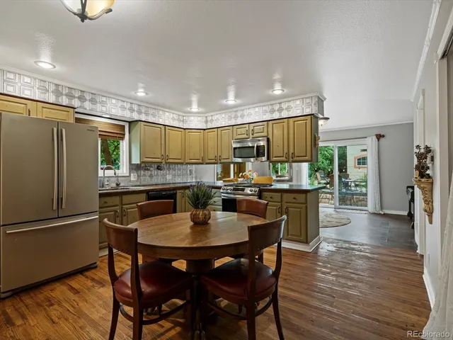 a kitchen with a table and chairs in it