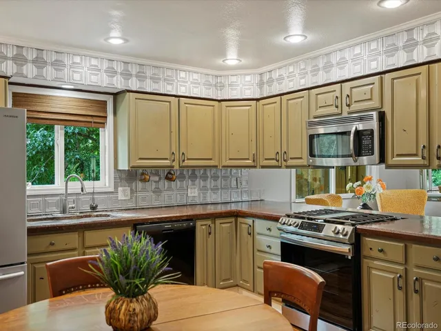 a kitchen with a sink stove and microwave