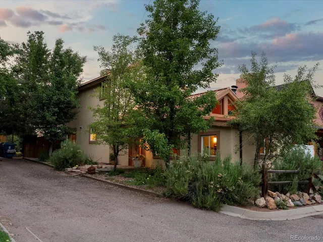 a view of house with outdoor space and trees around
