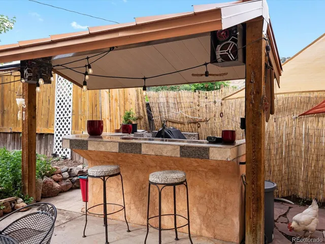 a patio with wooden table and chairs
