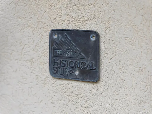 a view of a patio with table and chairs potted plants and a large tree