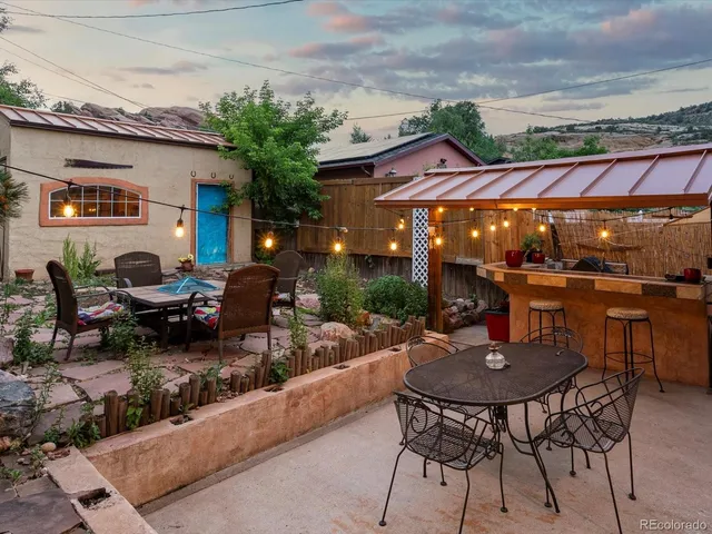 a view of a patio with dining table and chairs with plants
